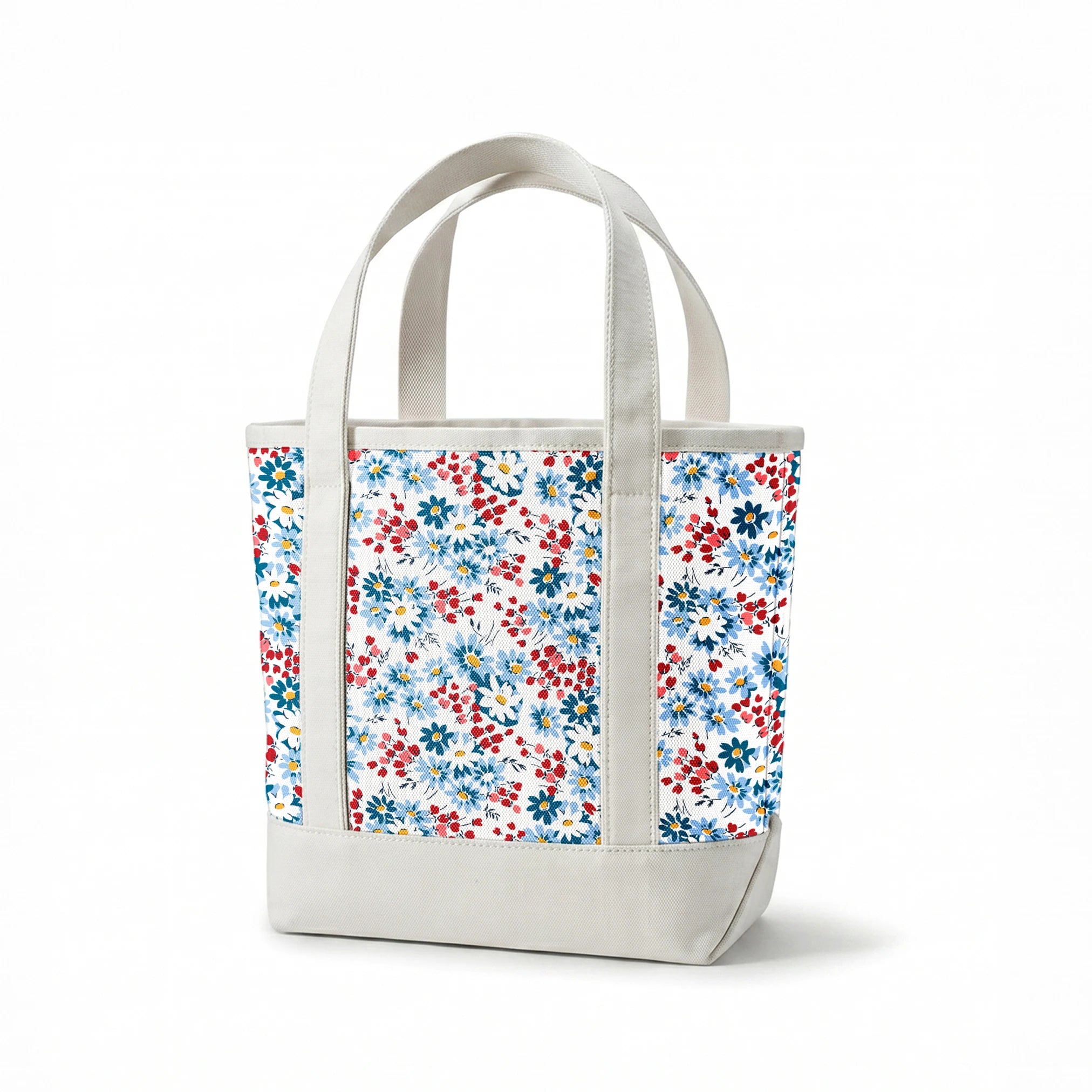 Blue and white daisies with small red berries scattered across a light background in a floral pattern springs canvastote mockup