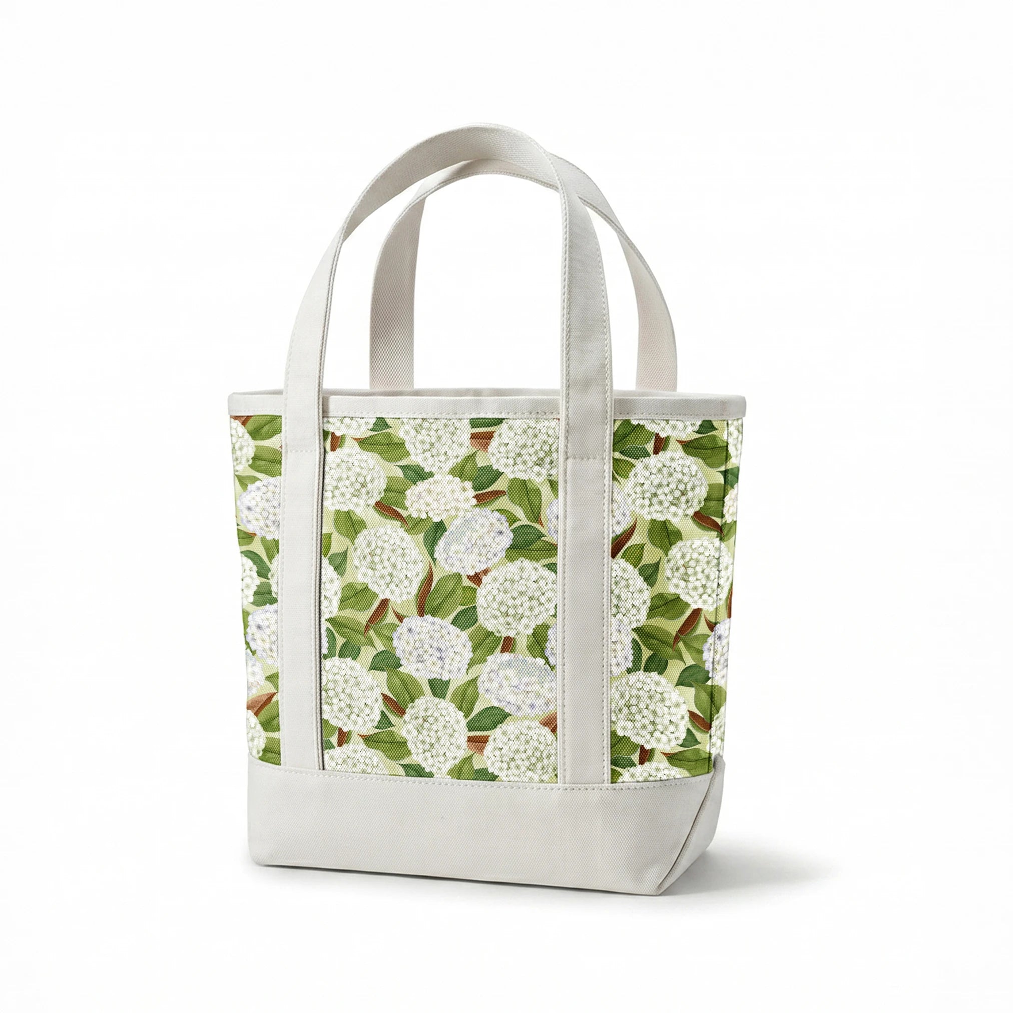 Realistic white hydrangea clusters with green leaves on a soft cream background, designed by Nicole Tamarin in a timeless botanical style. springs canvastote mockup