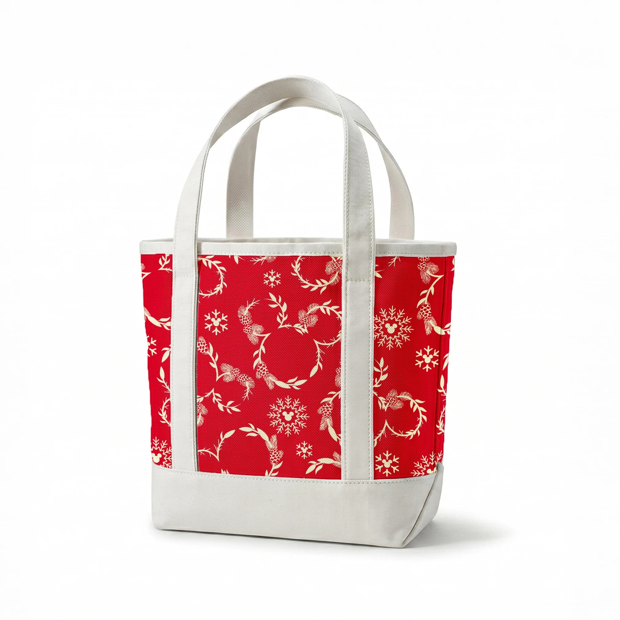 Festive red background with white floral wreaths, pine cones, and snowflake patterns springs canvastote mockup