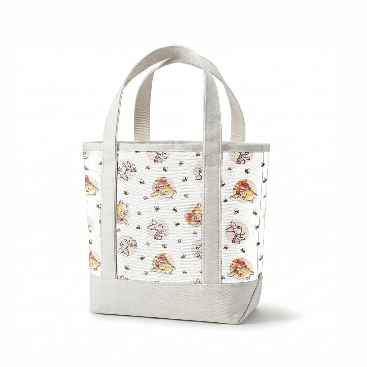Cute cartoon Winnie the Pooh and Piglet pattern with circular vignettes and buzzing bees springs canvastote mockup