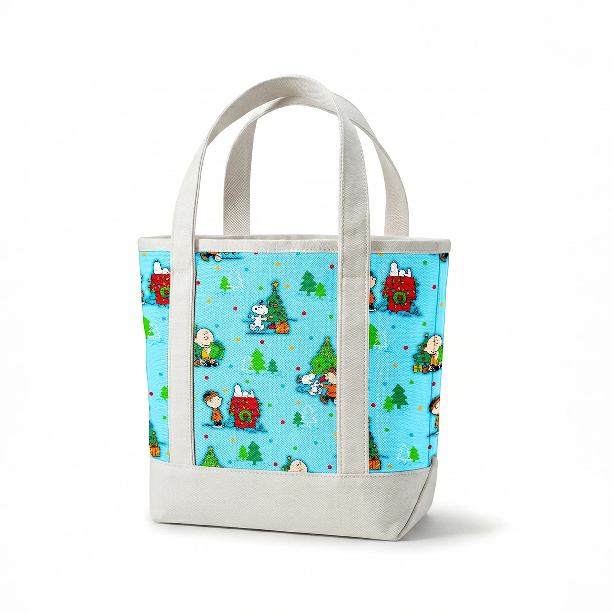 Peanuts Christmas pattern with Snoopy, Charlie Brown, and friends decorating trees on light blue background springs canvastote mockup