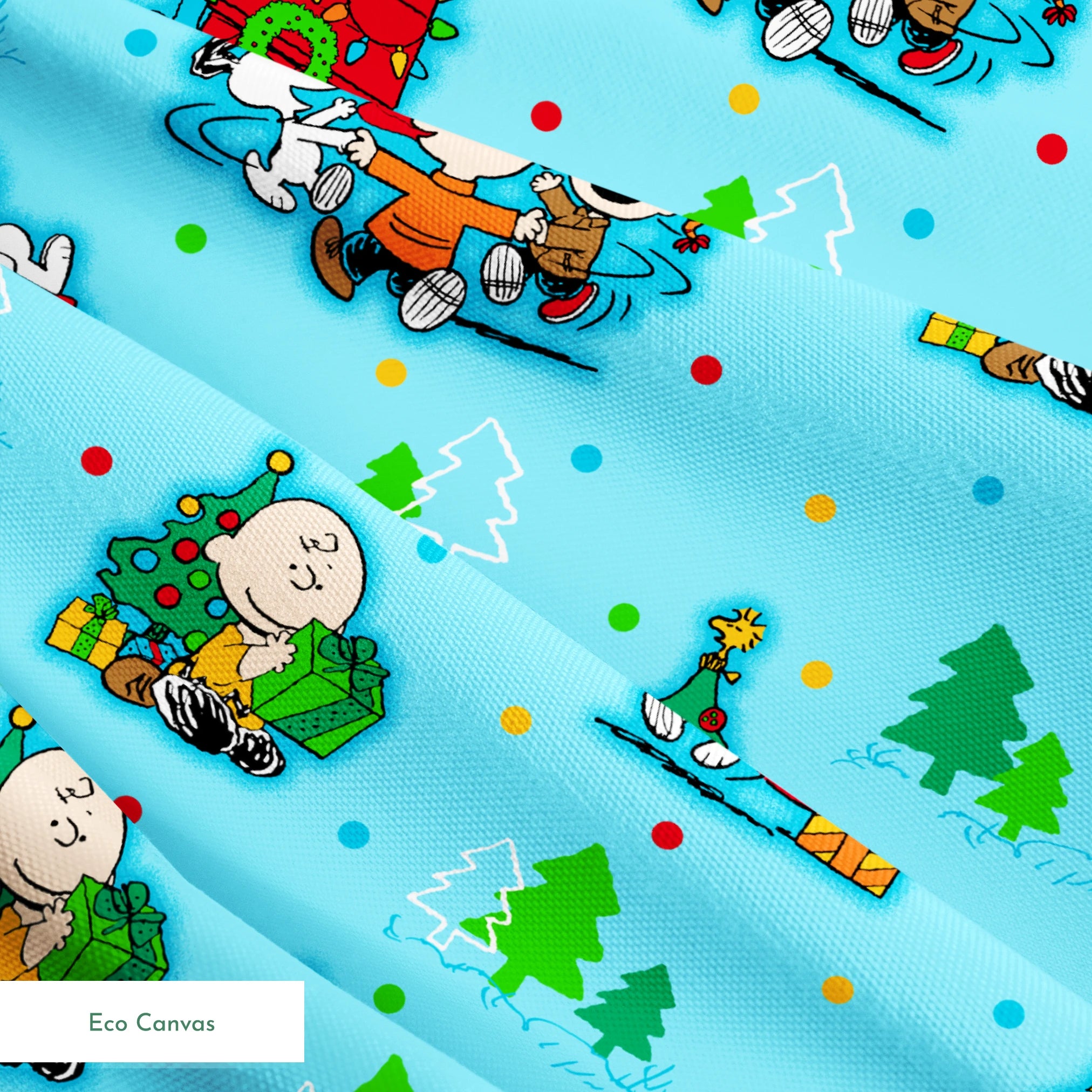 Peanuts Christmas pattern with Snoopy, Charlie Brown, and friends decorating trees on light blue background springs ecocanvas texture