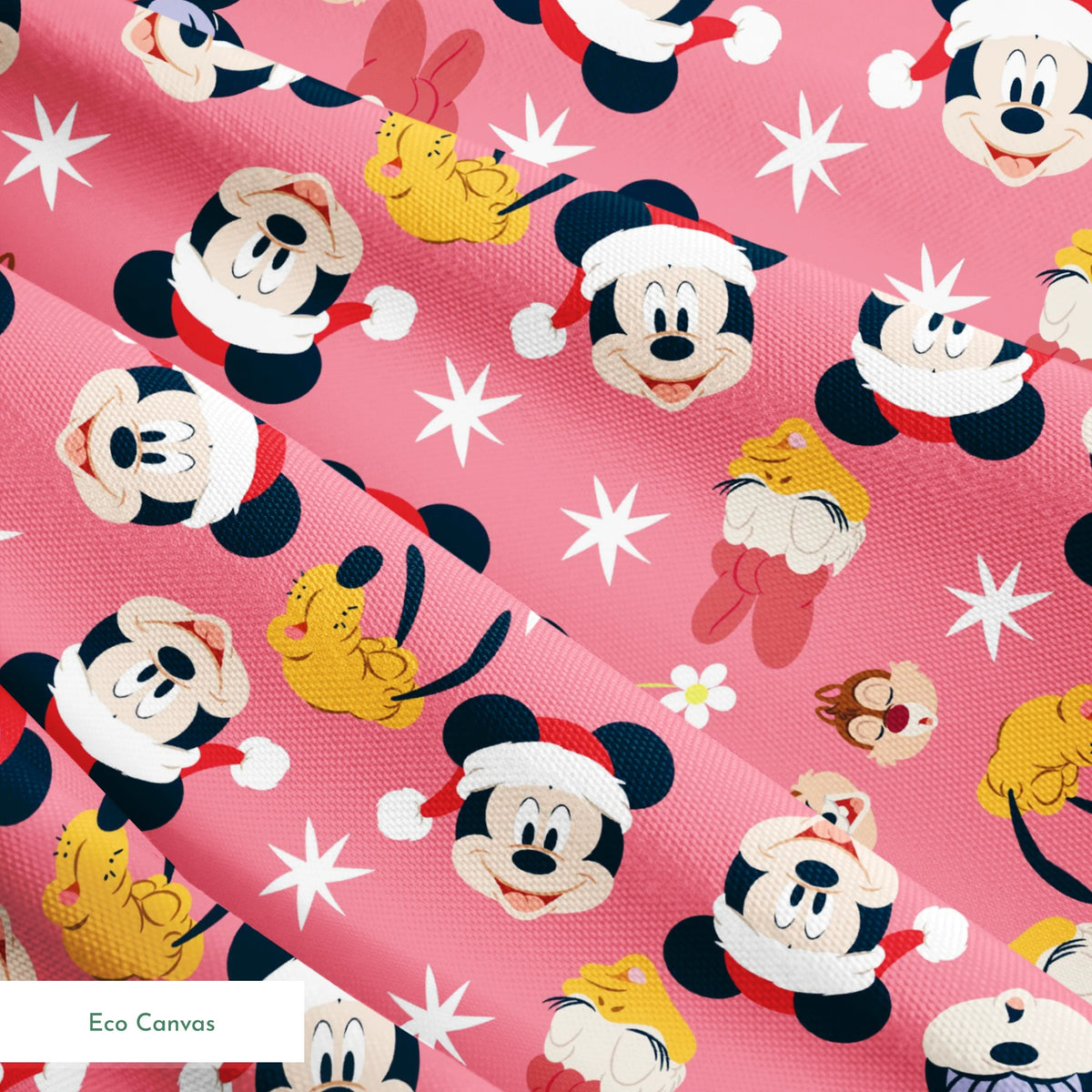 Mickey Mouse pattern with holiday elements on pink background, featuring white stars and gold accents springs ecocanvas texture