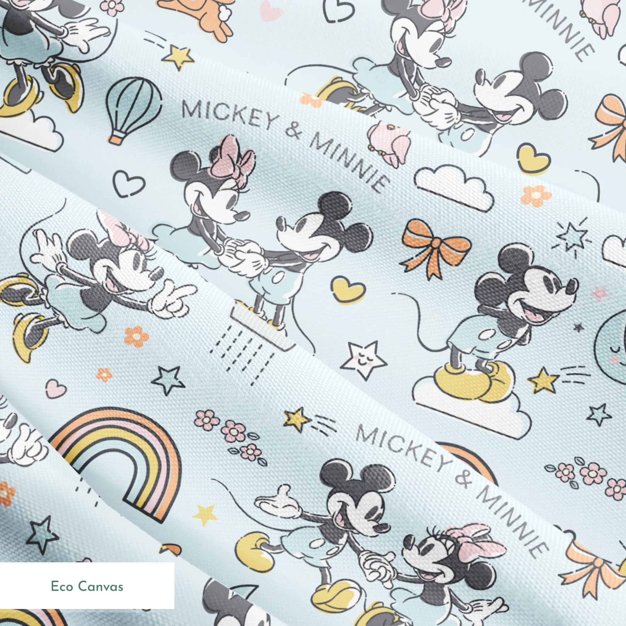 Playful Disney pattern with classic cartoon characters, rainbows, hearts, and whimsical elements on light blue background. springs ecocanvas texture