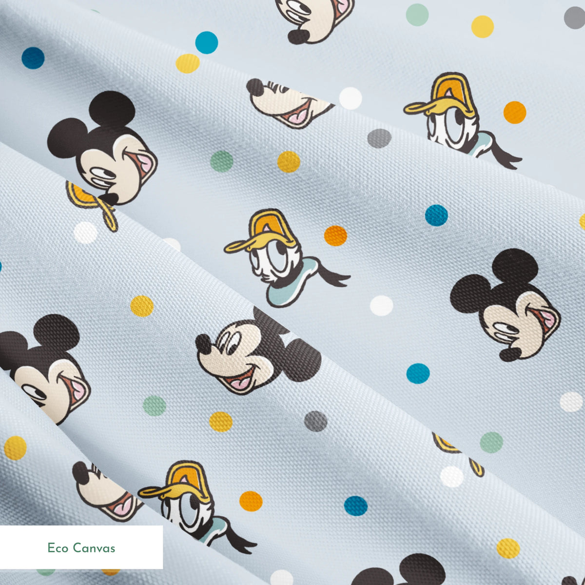 Disney character pattern with Mickey Mouse and Donald Duck heads scattered on light blue background with colorful polka dots springs ecocanvas texture