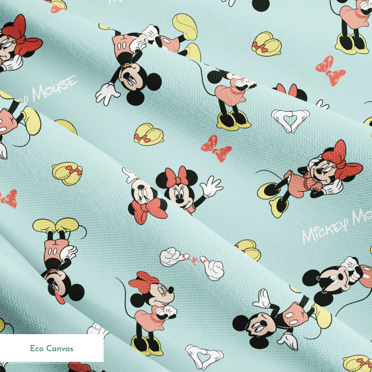 Mickey and Minnie Mouse pattern on light turquoise background with scattered characters, bows, and gloves springs ecocanvas texture