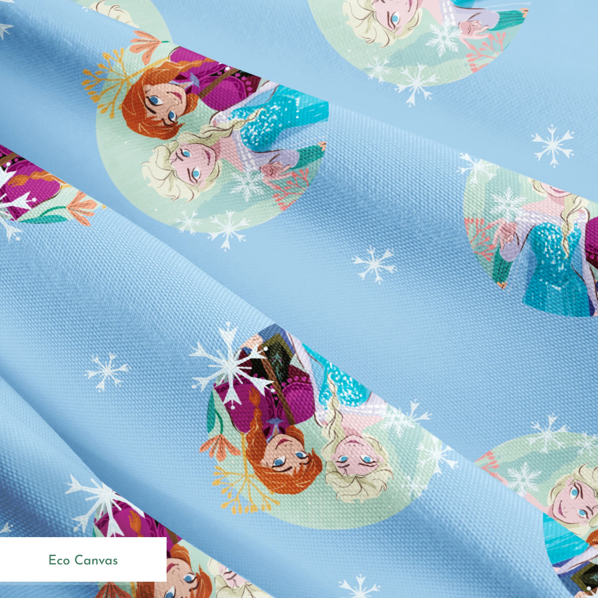 Light blue background with repeating circular motifs of "Frozen" characters and snowflakes in a decorative pattern springs ecocanvas texture