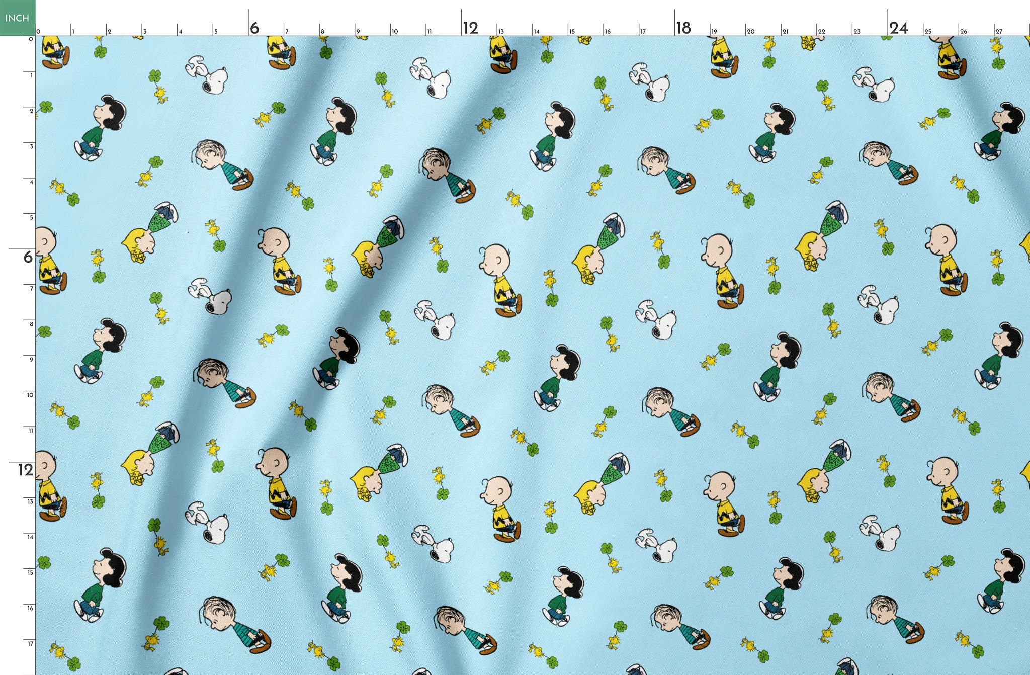 Peanuts cartoon characters on light blue background with clovers springs fatquarter mockup