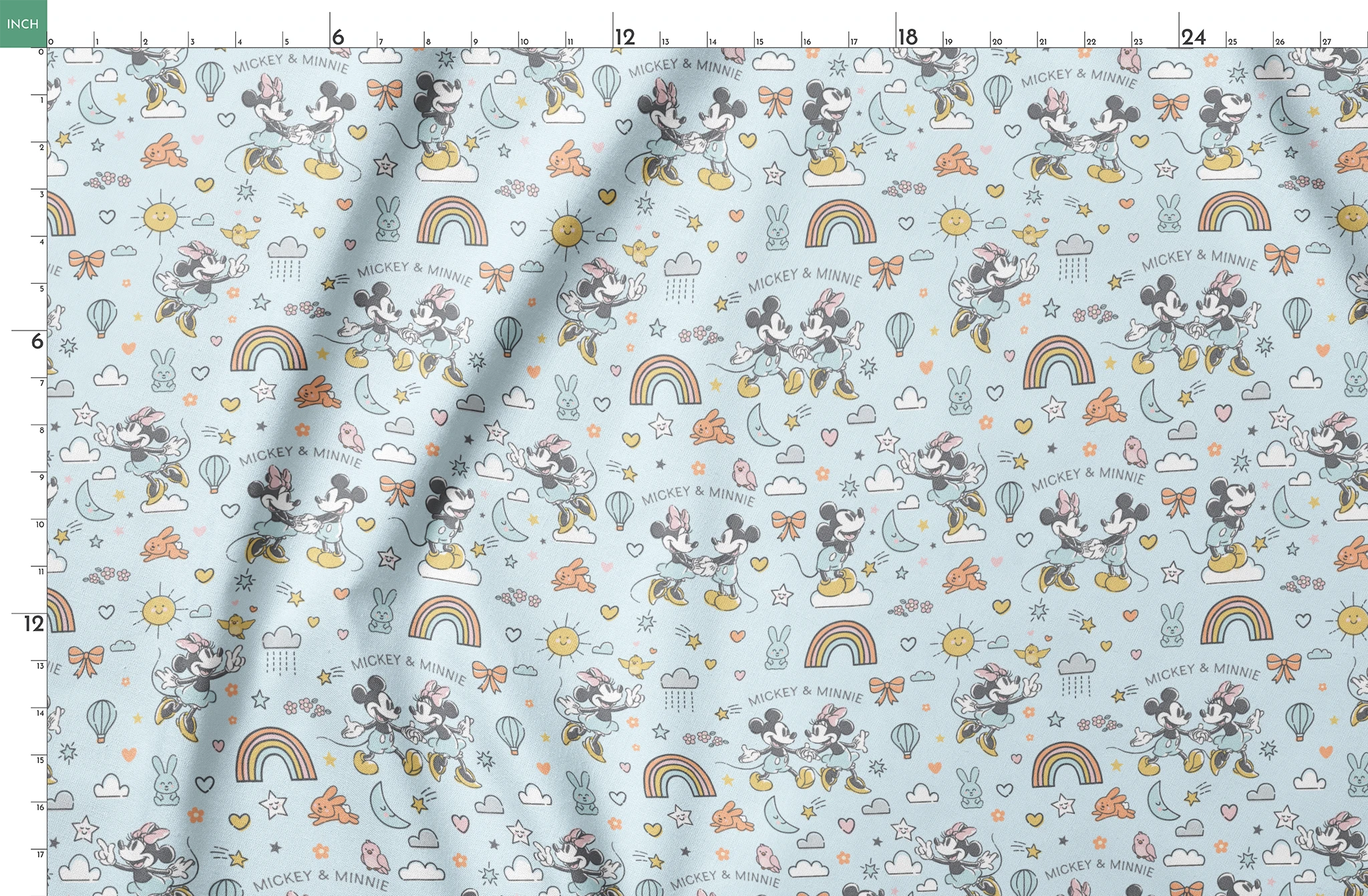 Playful Disney pattern with classic cartoon characters, rainbows, hearts, and whimsical elements on light blue background. springs fatquarter mockup