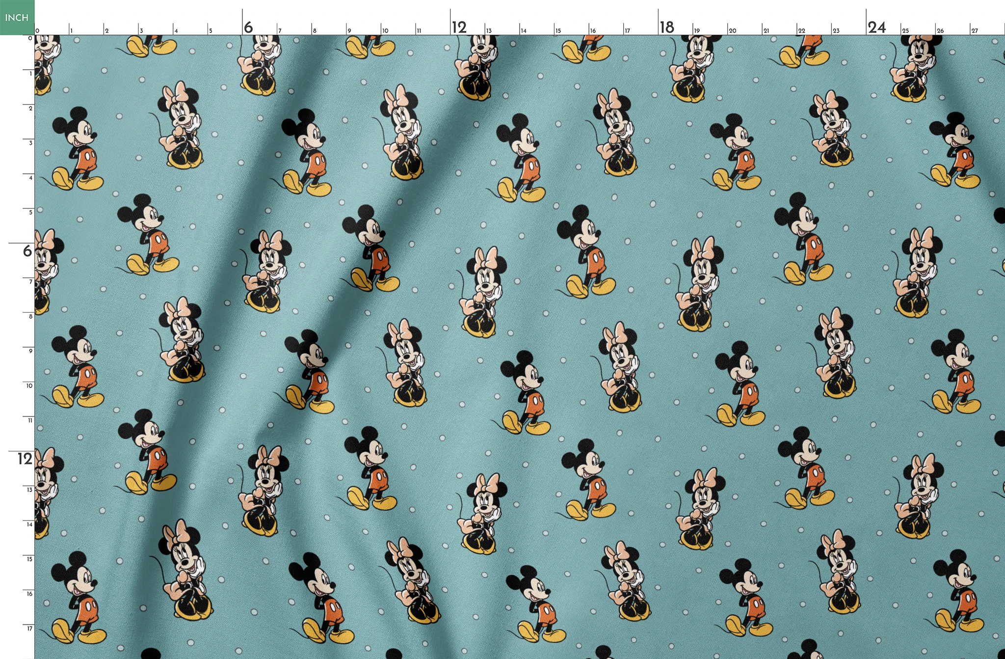 Cartoon pattern of Mickey and Minnie Mouse characters on light blue background with white dots springs fatquarter mockup