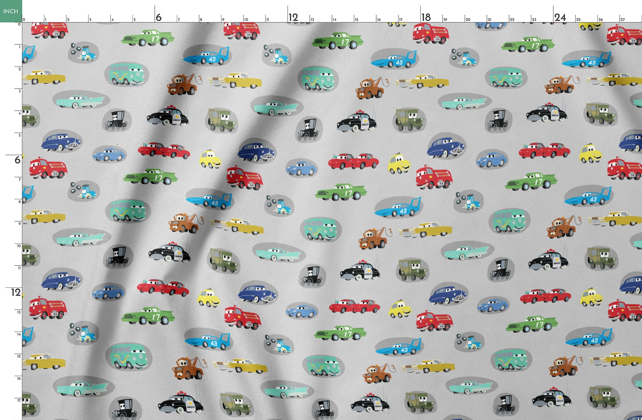 Various cartoon toy cars and vehicles in different colors (red, blue, green, yellow) displayed against a gray background with cute animated faces. springs fatquarter mockup