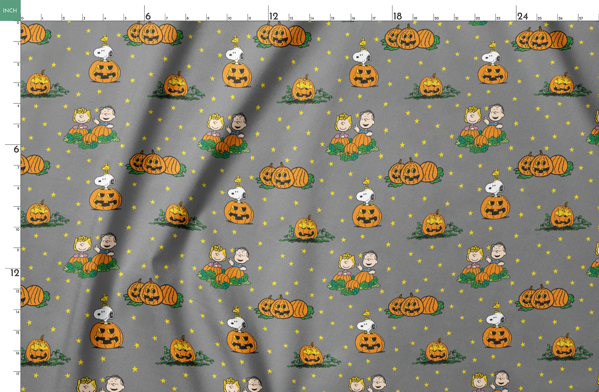 Peanuts Halloween pattern with Snoopy on pumpkins, Peanuts characters in pumpkin patches, and yellow stars on gray background. springs fatquarter mockup