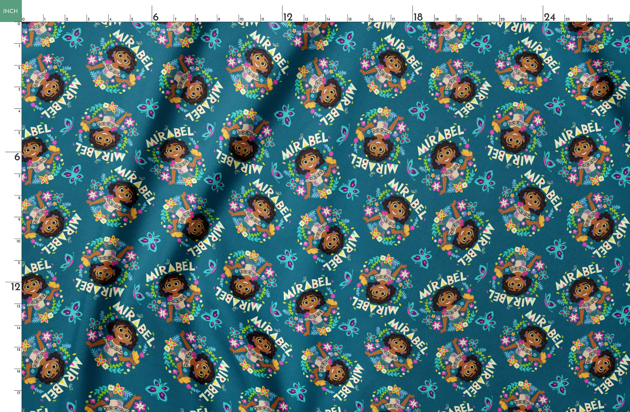 Colorful cartoon pattern on teal background featuring characters, butterflies, flowers, and "Mirabel" text in repeating design springs fatquarter mockup