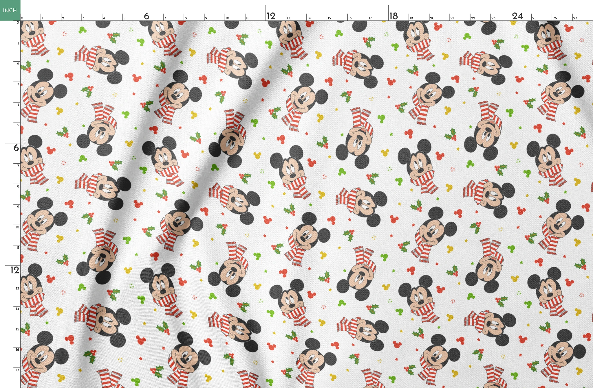 Mickey Mouse wearing red striped scarves, surrounded by holly and colorful icons on white background springs fatquarter mockup