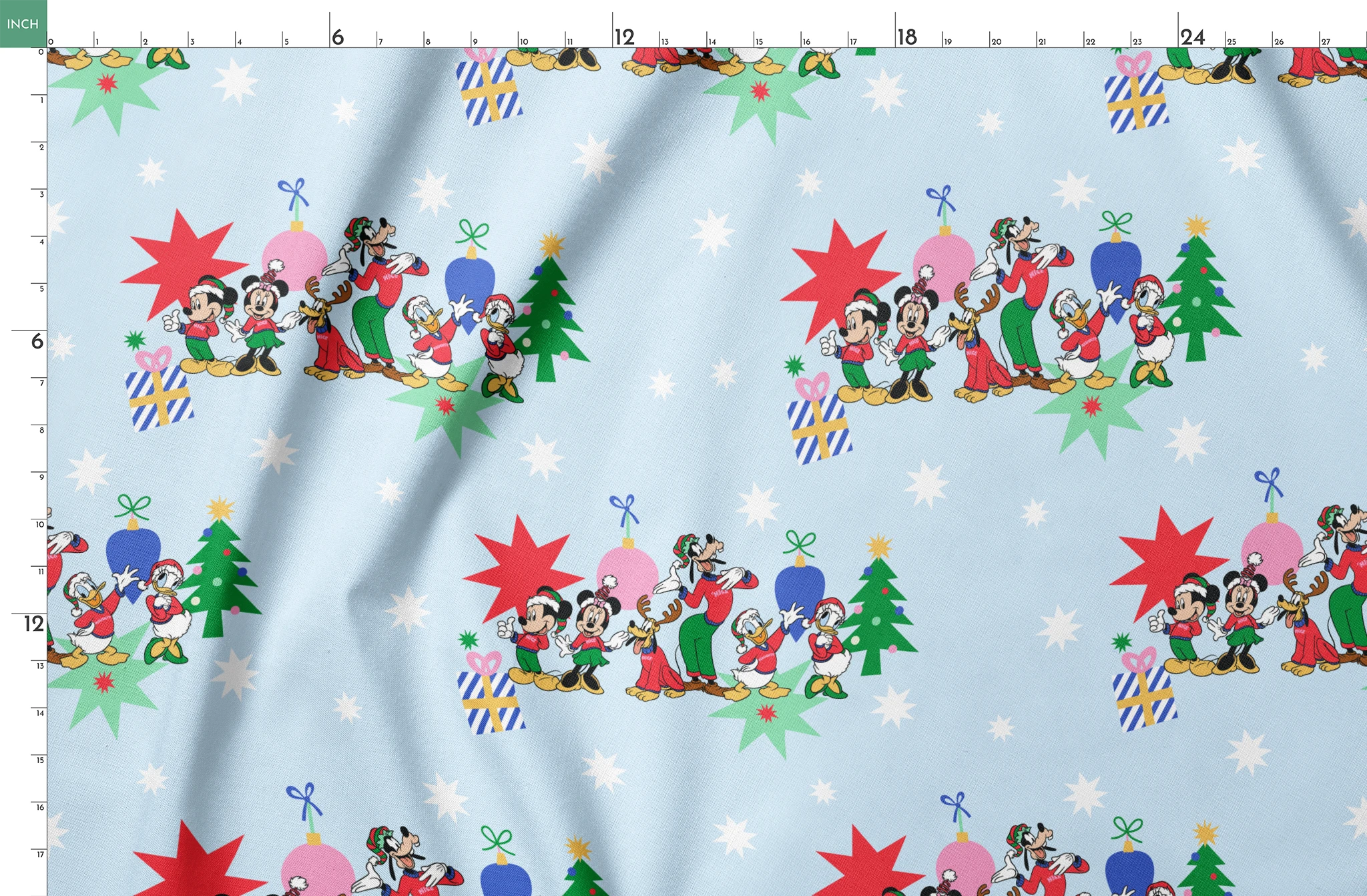 Cartoon Disney characters in festive poses with Christmas trees, ornaments, and stars on light blue snowy background springs fatquarter mockup