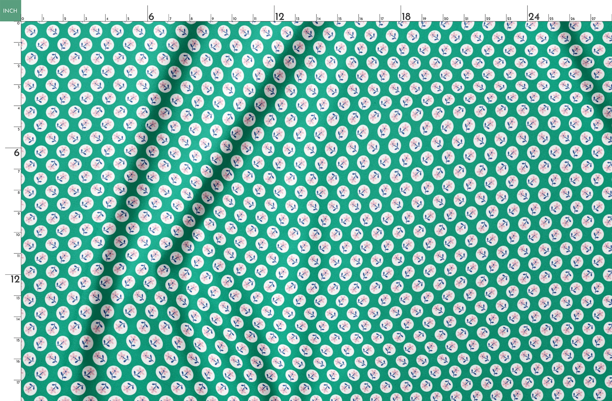 Pink flower motifs with blue stems on white circles against a green background springs fatquarter mockup