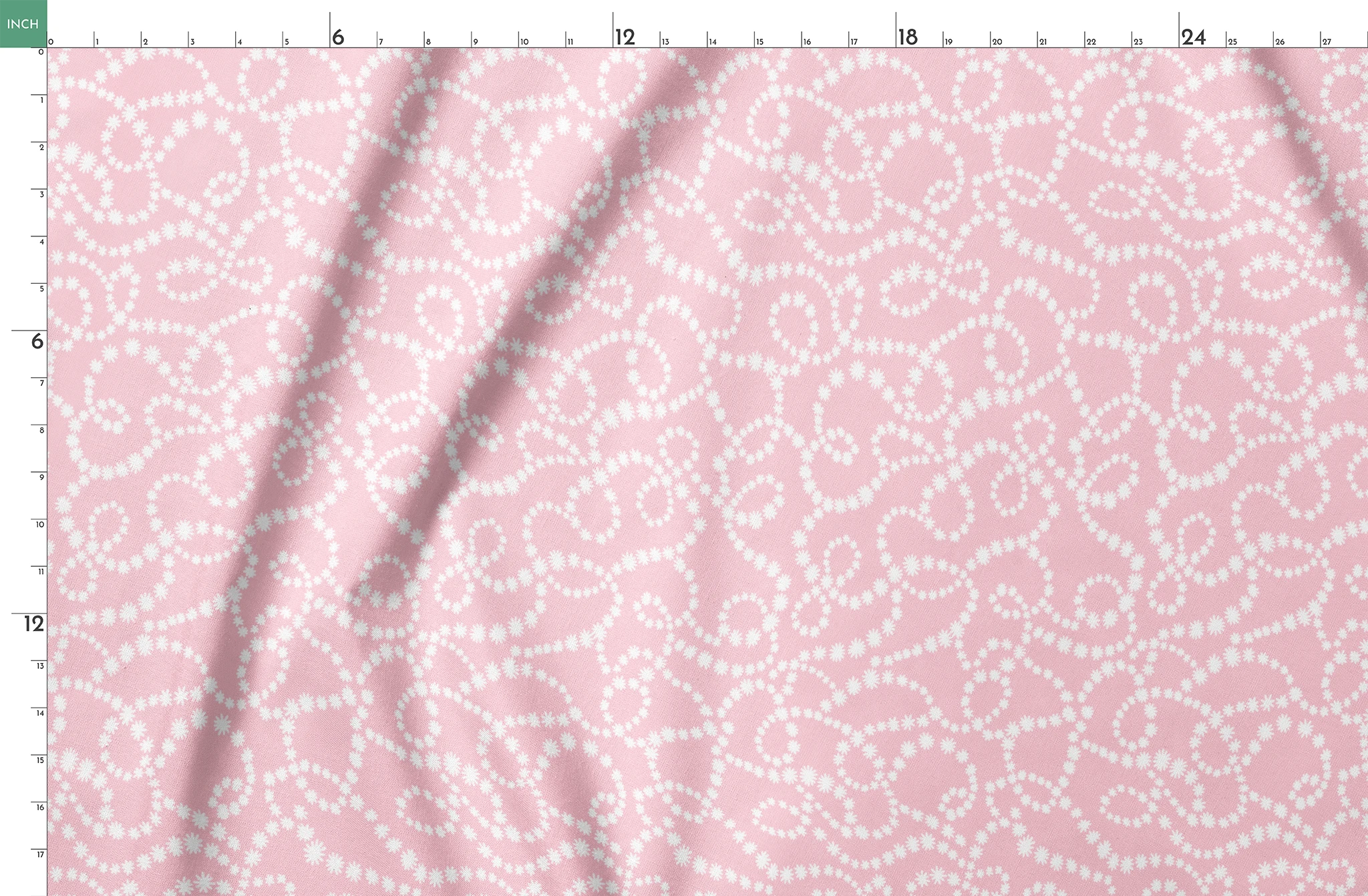 Baby pink background with white dotted swirling pattern creating delicate curved lines and loops springs fatquarter mockup