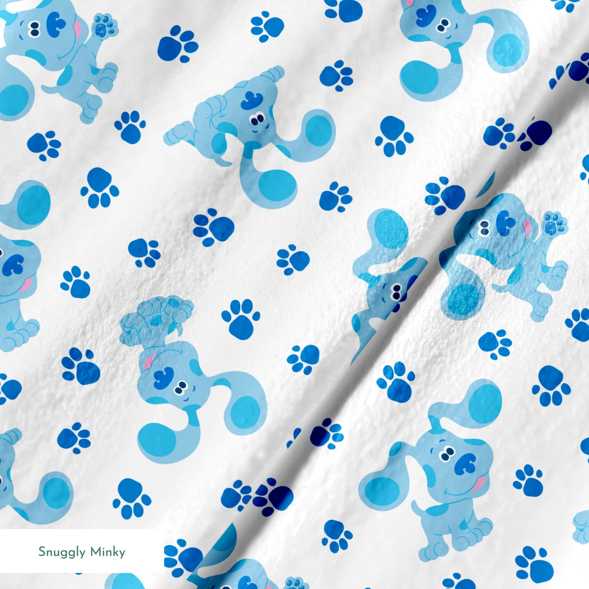 Blue cartoon puppies with floppy ears scattered among paw print pattern on white background springs minky texture