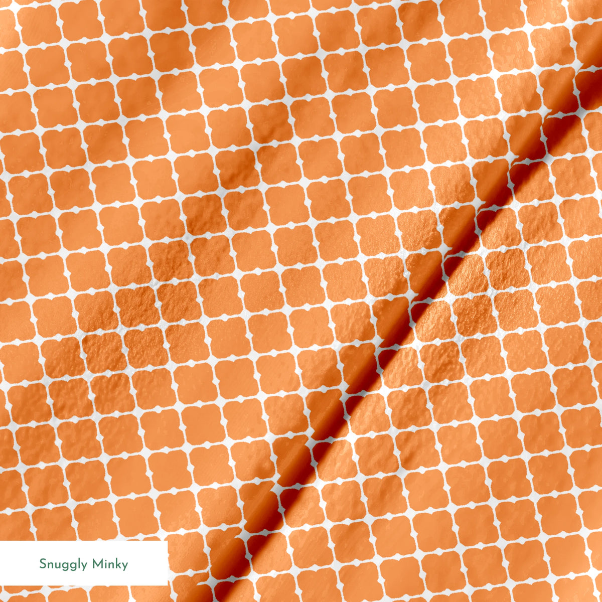 Geometric orange and white pattern with quatrefoil shapes forming a lattice design springs minky texture