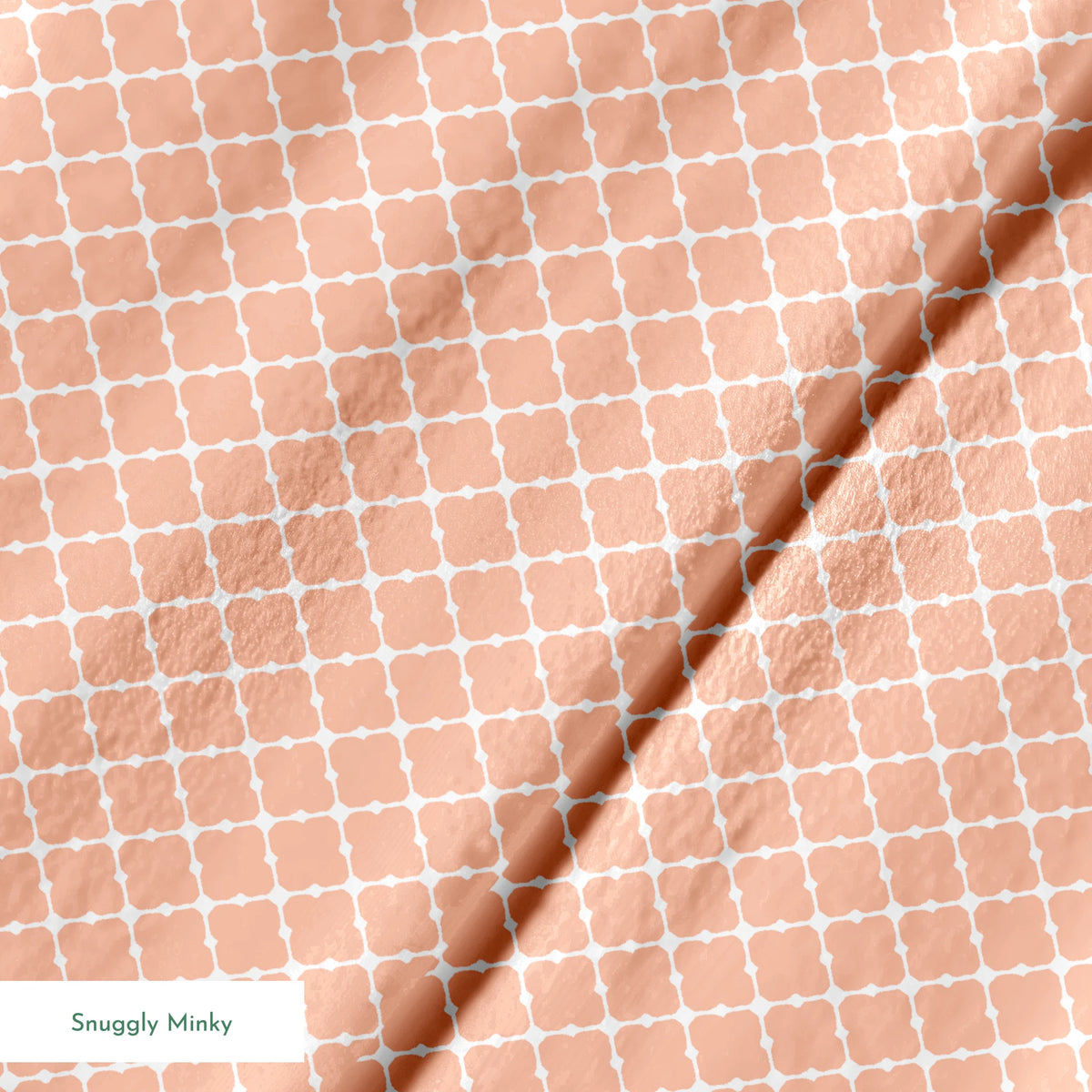Peach and white quatrefoil pattern with regular geometric shapes in a lattice arrangement springs minky texture
