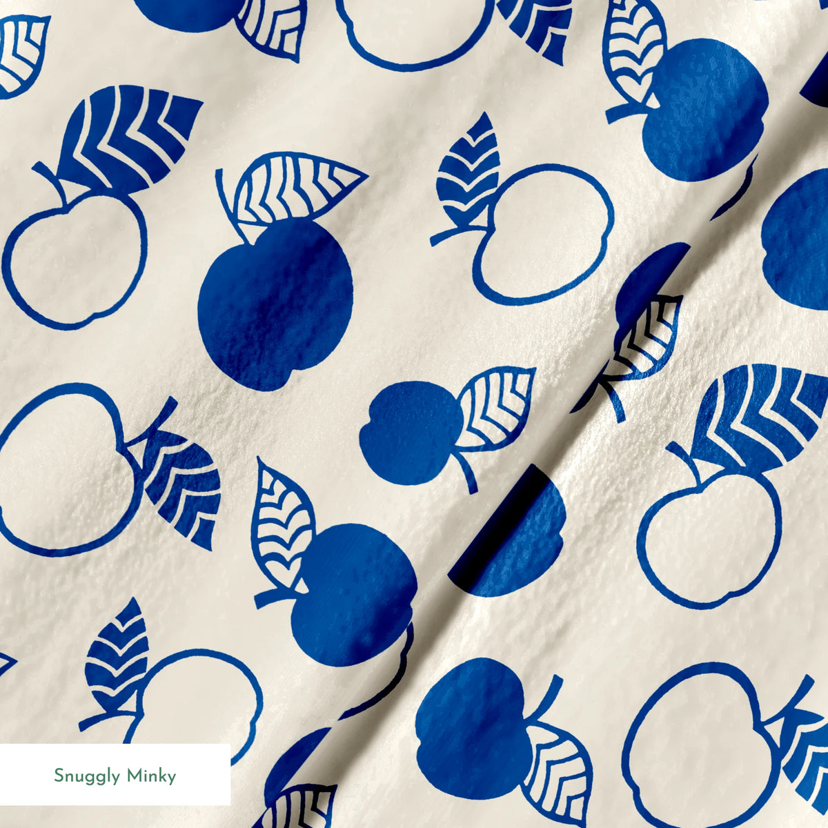 Blue apple illustrations and leaf outlines arranged in a scattered pattern on cream background. springs minky texture