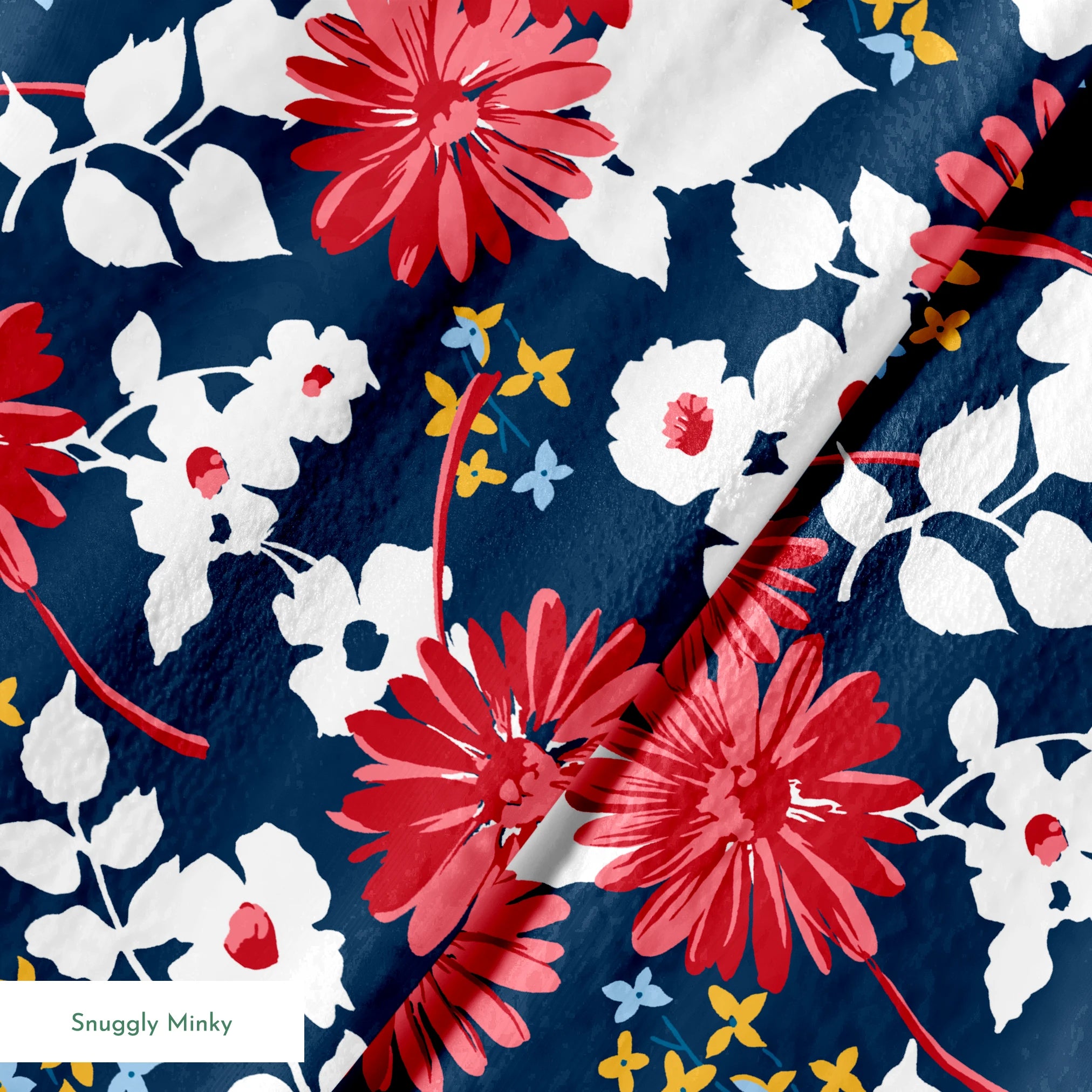 Vibrant floral pattern with red daisies and white flowers on navy background with small gold stars springs minky texture