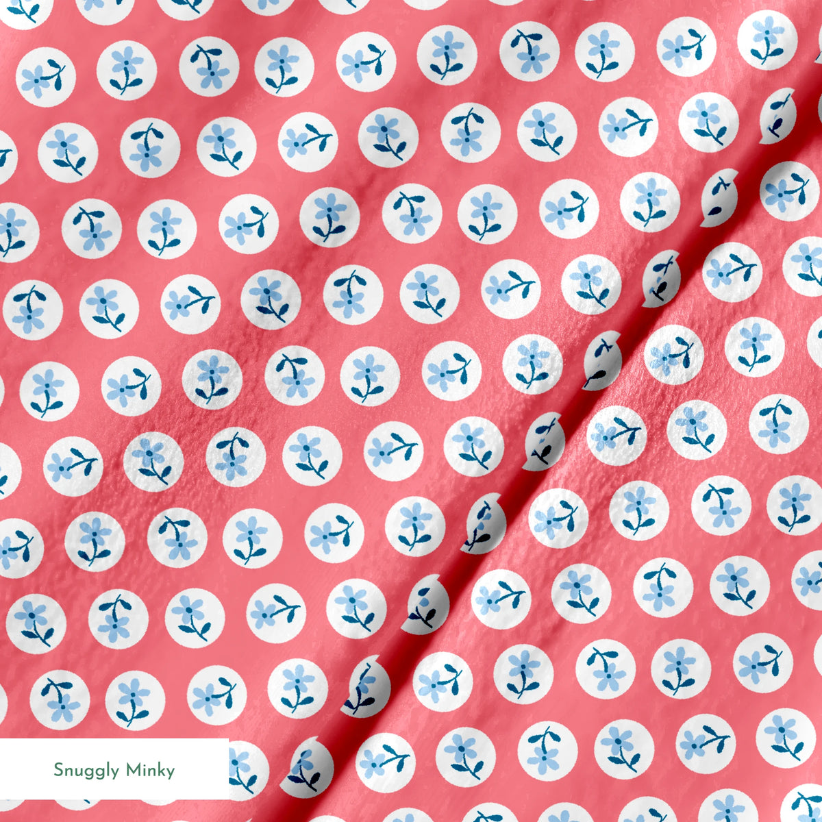 Coral pink background with white circles containing light blue floral designs arranged in a pattern springs minky texture