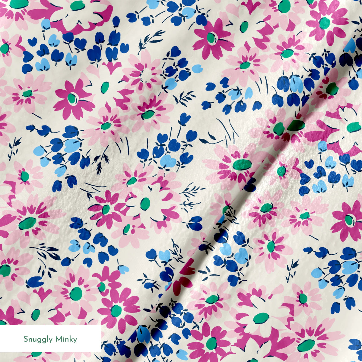 Colorful floral pattern with pink and magenta daisies, blue berries, and green accents on cream background springs minky texture