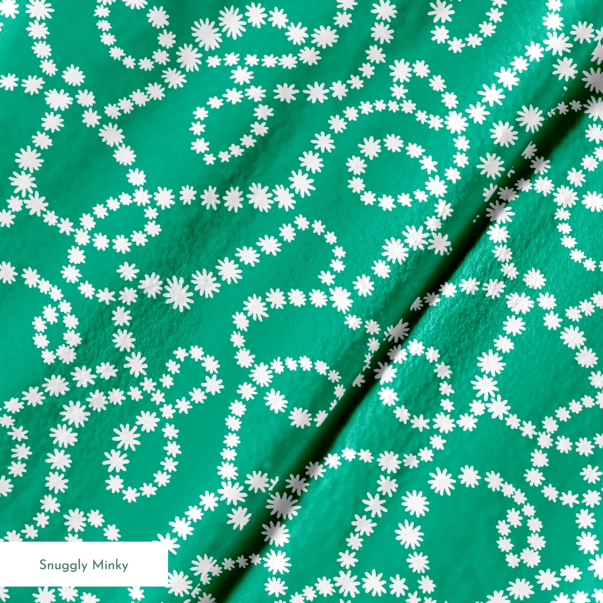 White dotted swirling patterns on green background forming abstract curving lines springs minky texture