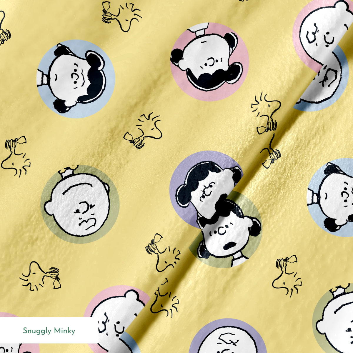 Peanuts characters pattern with Charlie Brown and friends in circular frames on yellow background with Woodstock silhouettes springs minky texture