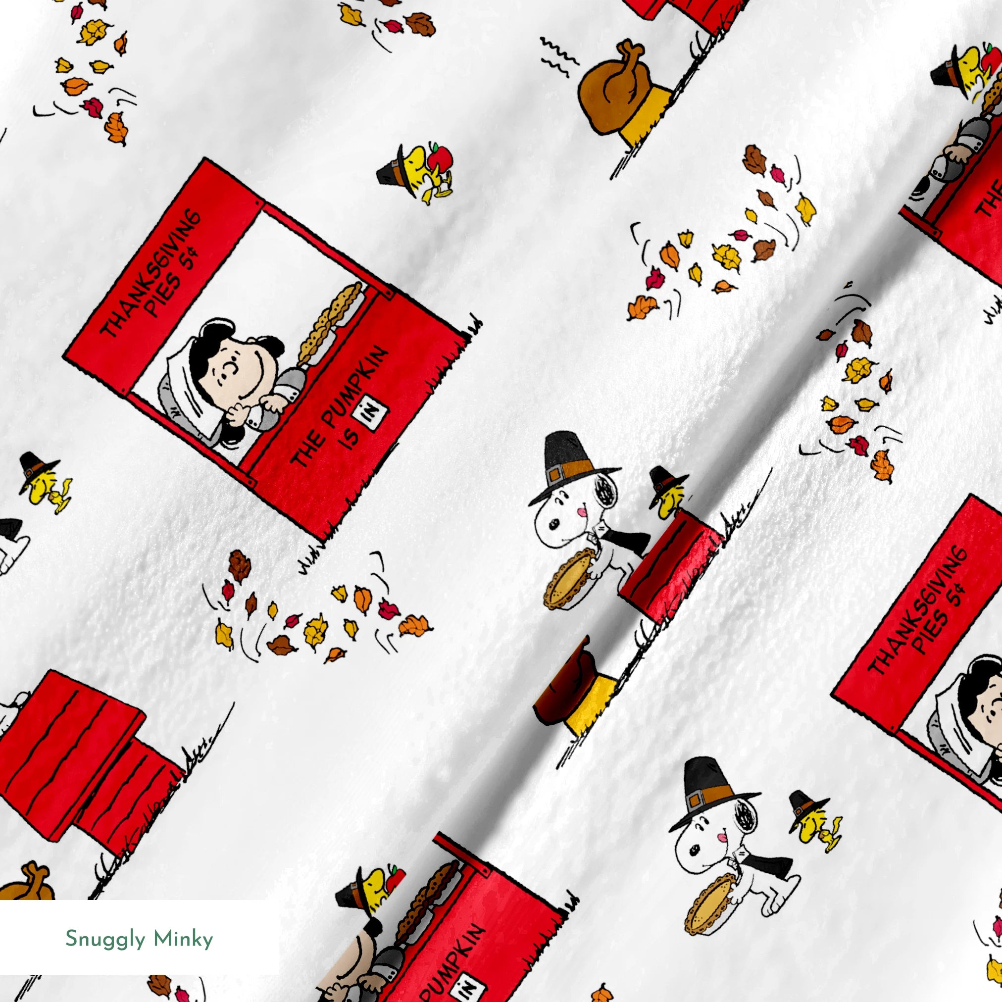 Peanuts Thanksgiving pattern with Snoopy, red booths, doghouses, and falling autumn leaves on white background springs minky texture