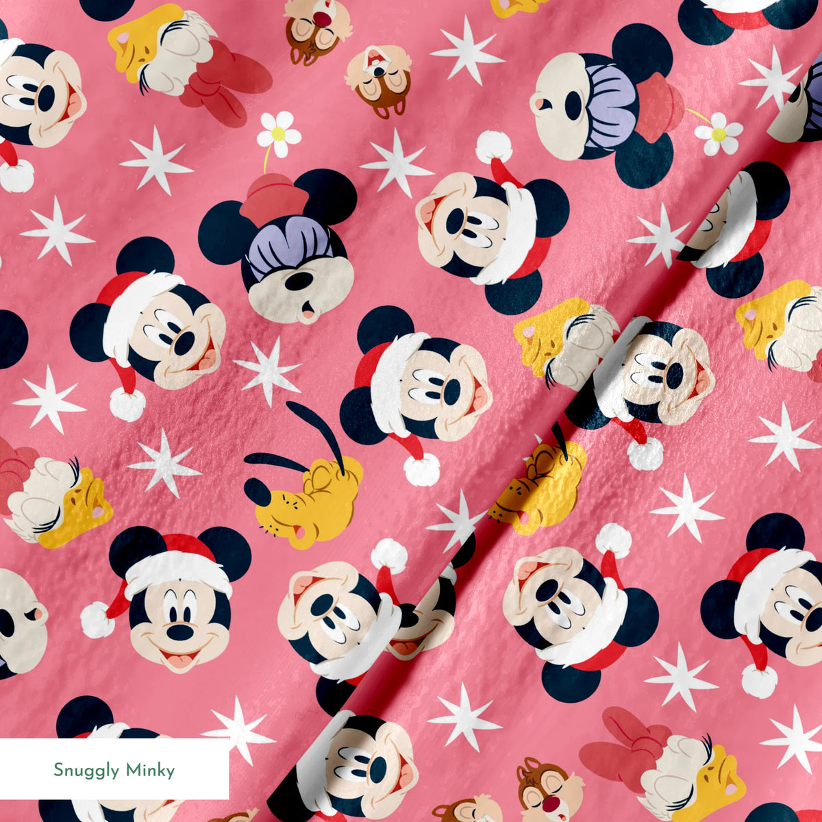 Mickey Mouse pattern with holiday elements on pink background, featuring white stars and gold accents springs minky texture