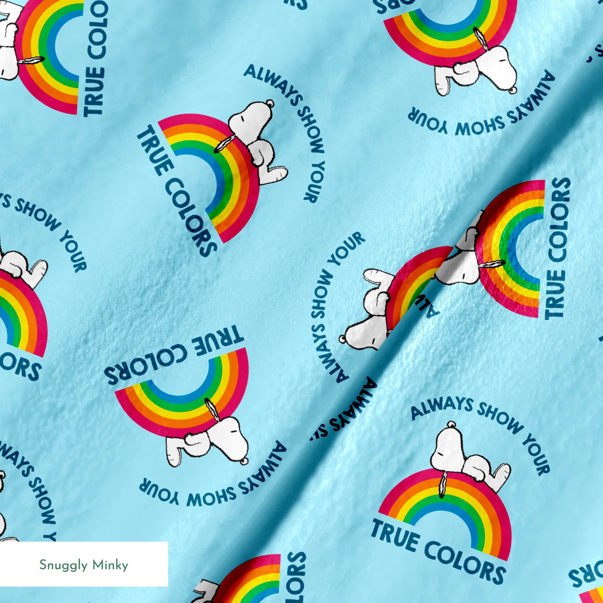 Rainbow Snoopy pattern on light blue background with white clouds and "TRUE COLORS" and "ALWAYS SHOW YOUR" text repeated throughout design springs minky texture