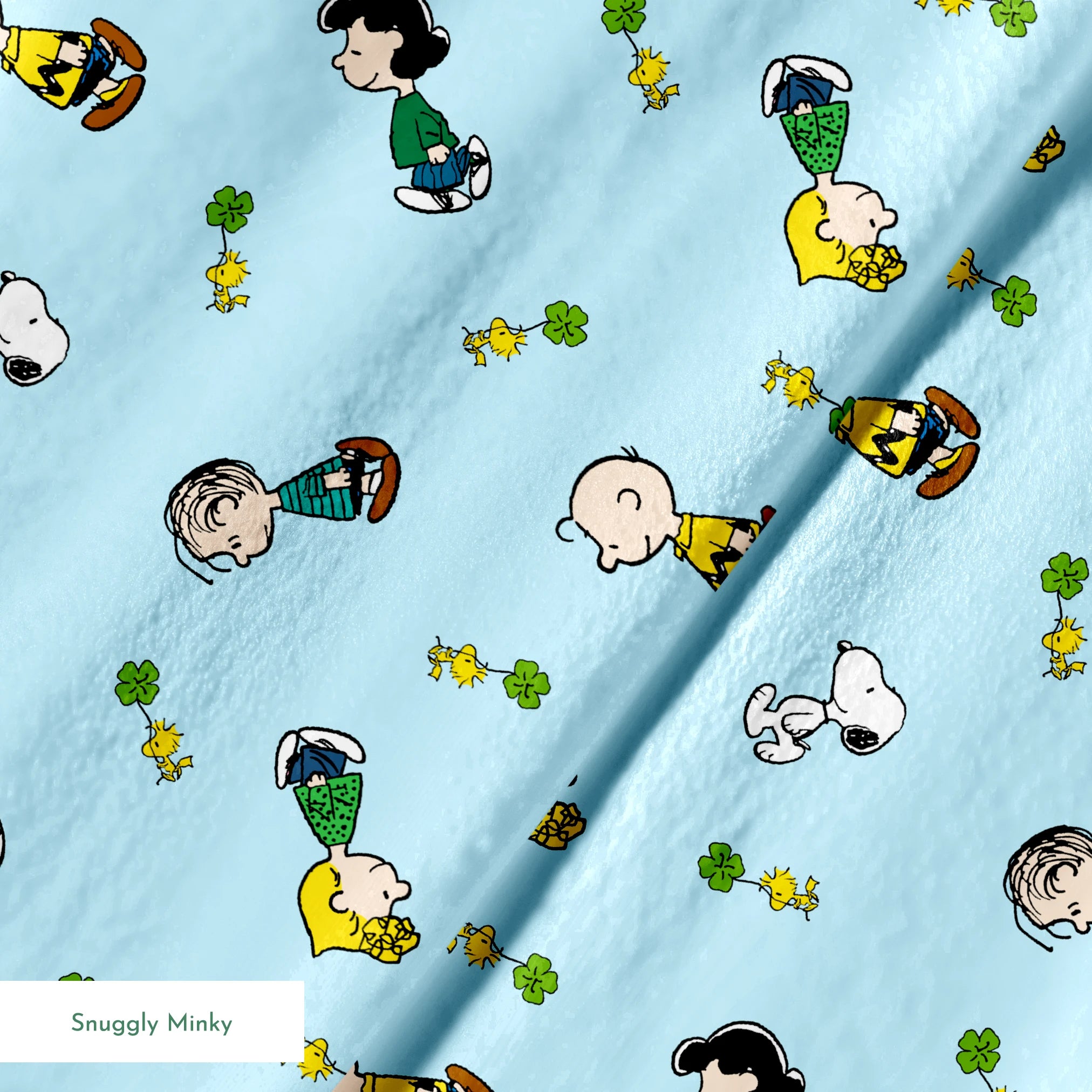 Peanuts cartoon characters on light blue background with clovers springs minky texture