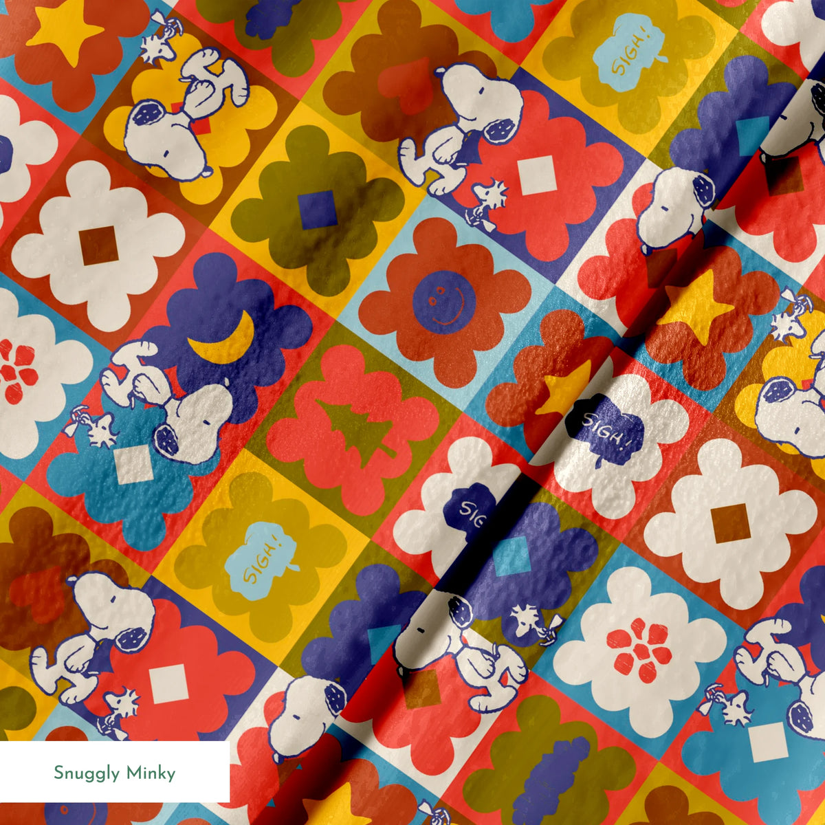 Colorful patchwork pattern featuring Snoopy characters in various squares with flowers, geometric shapes, and decorative elements springs minky texture