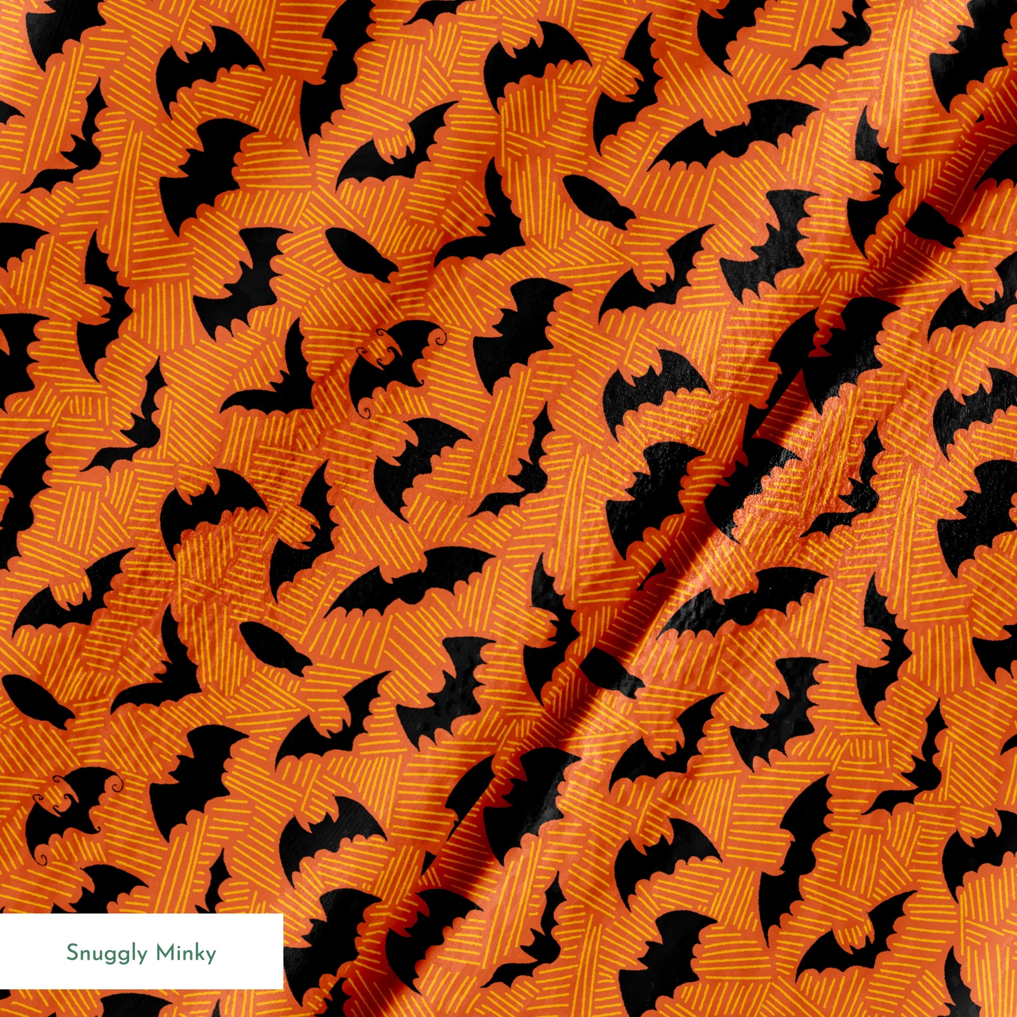 Halloween pattern with black bats scattered across an orange textured background springs minky texture