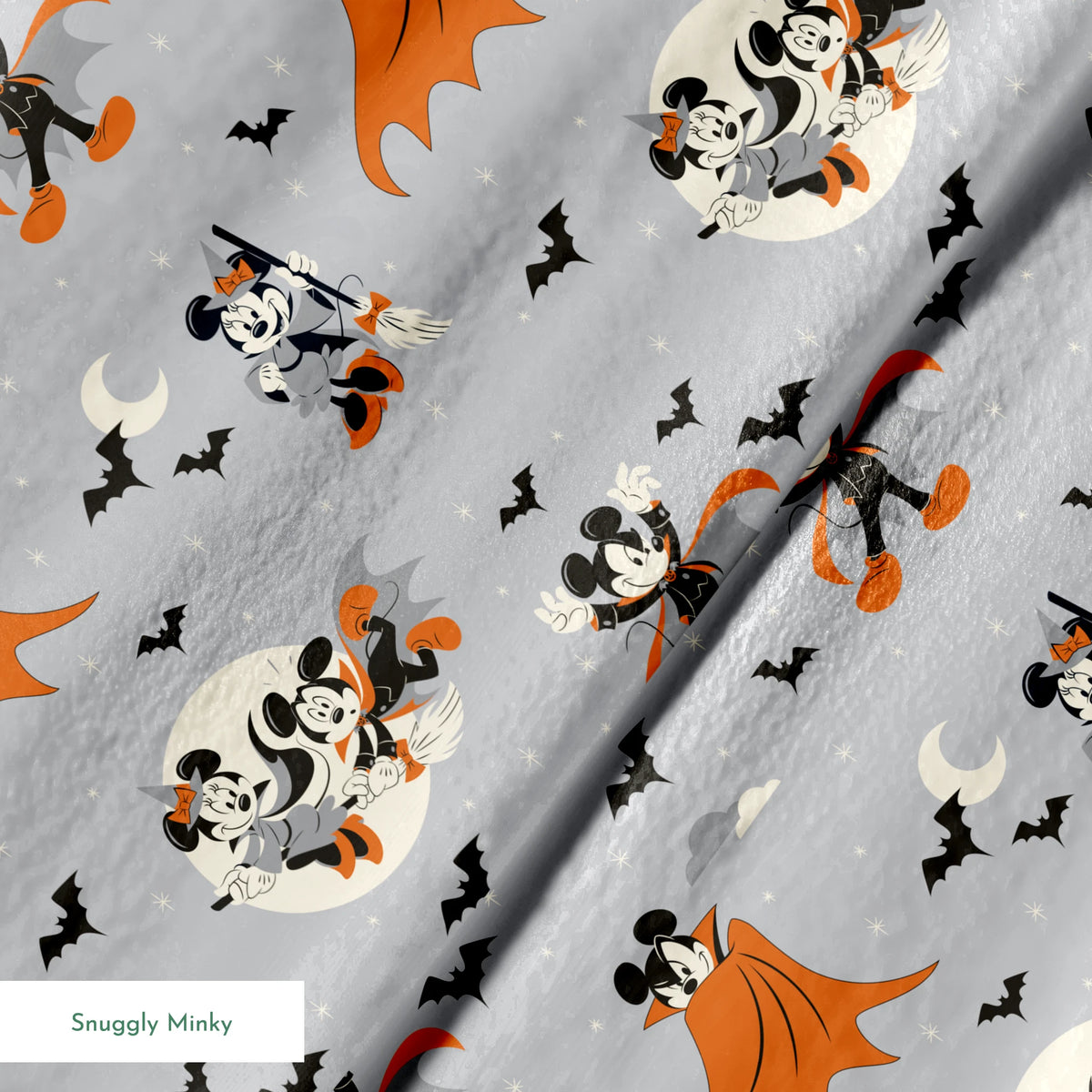 Mickey and Minnie Mouse in Halloween costumes on gray background with bats and moons, orange capes and spooky theme. springs minky texture