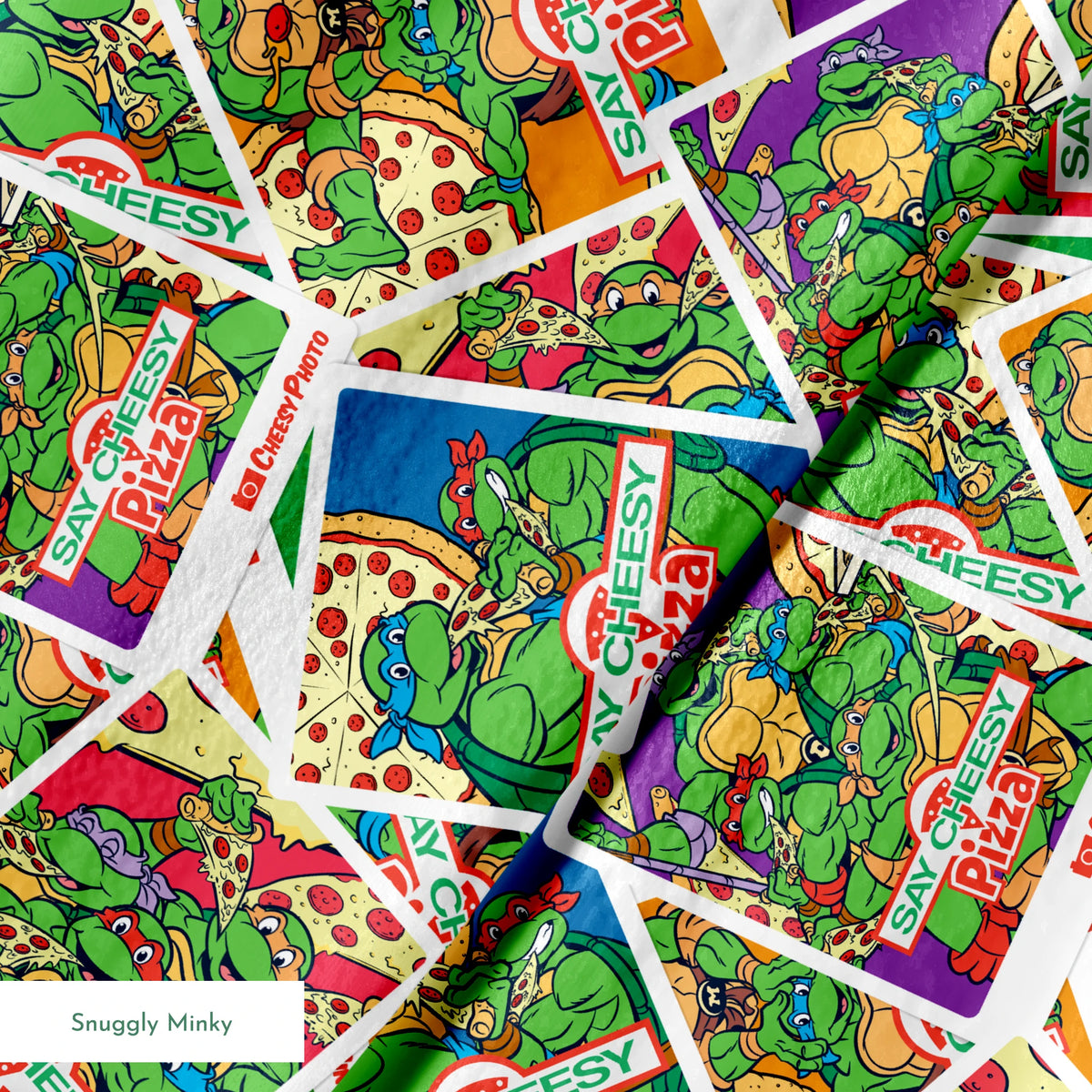 Scattered vintage Teenage Mutant Ninja Turtles trading cards with colorful comic-style artwork springs minky texture