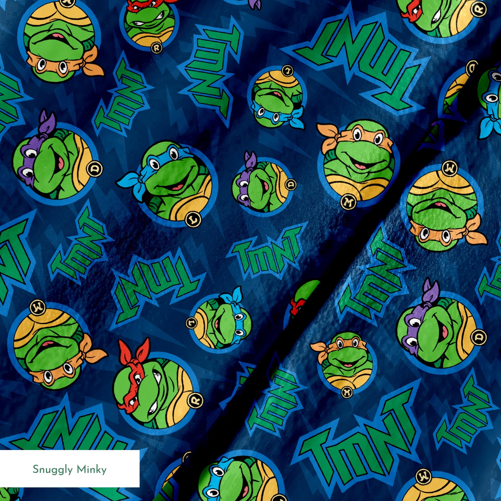 Teenage Mutant Ninja Turtles pattern with character heads and TMNT logos on blue background springs minky texture