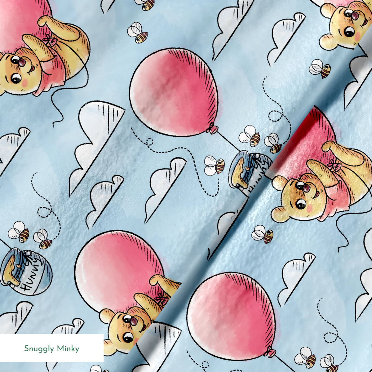 Cute yellow bear characters floating with pink balloons and honey pots against a blue sky with cl... springs minky texture