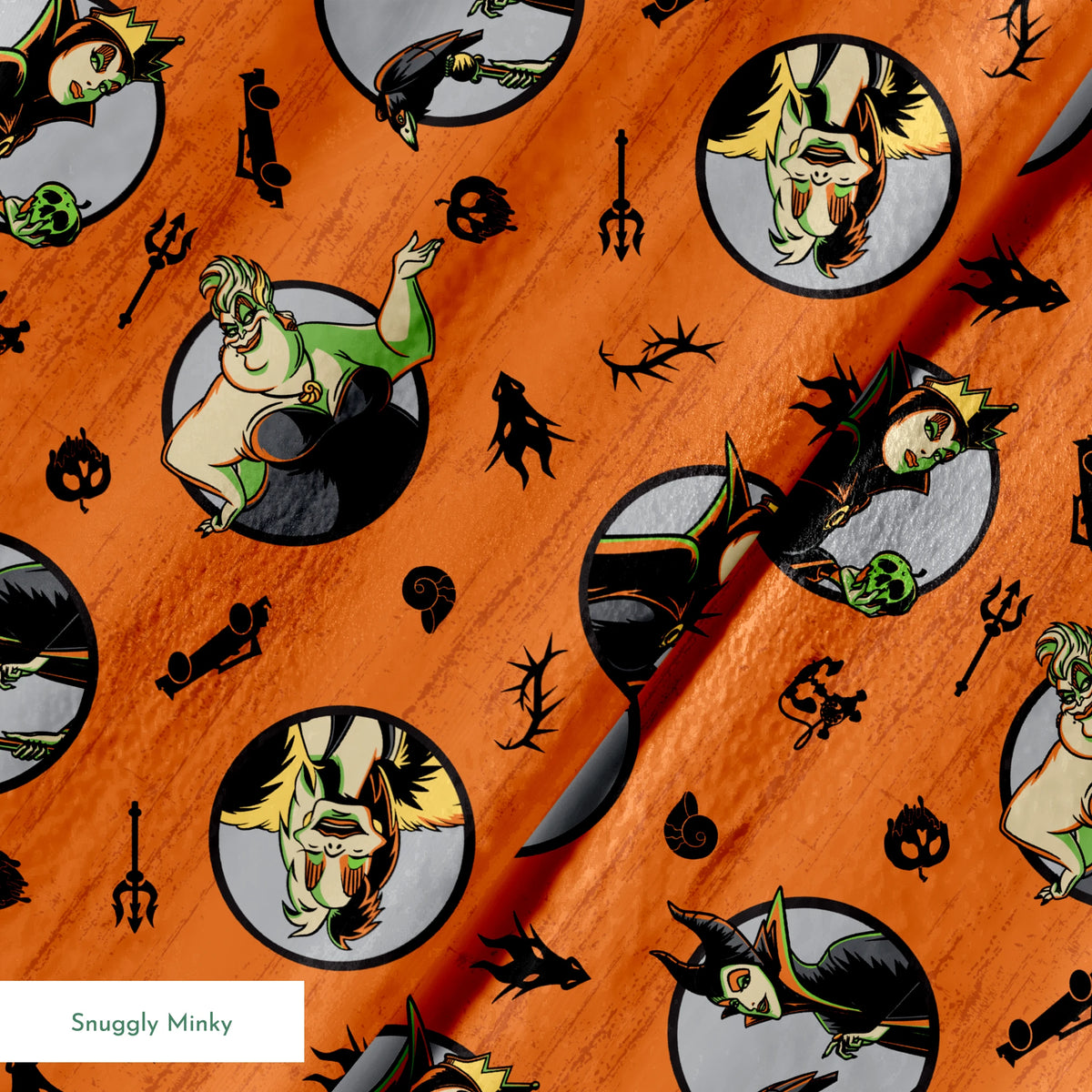 Halloween-themed orange pattern with circular Disney Villain portraits, black cats, bats, pumpkins, and spooky symbols springs minky texture