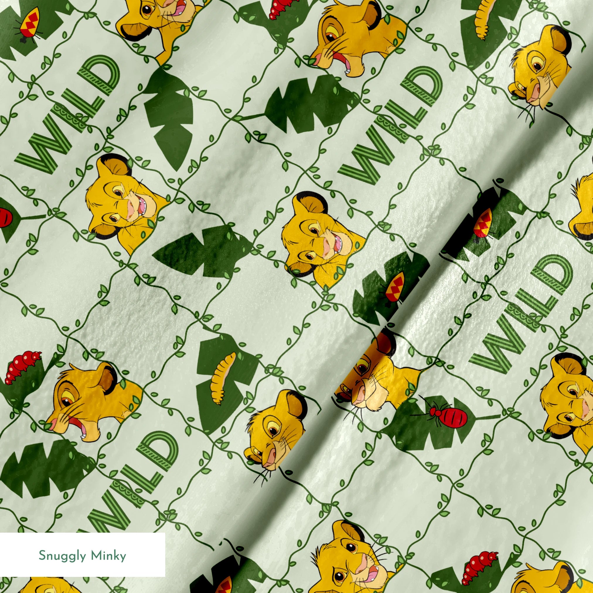 Young cartoon lion cubs with tropical leaves and "WILD" text on light green background pattern springs minky texture