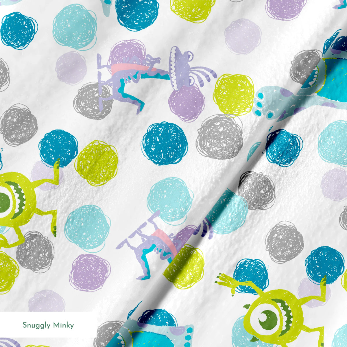 Colorful pattern featuring cartoon monsters with polka dots in blue, green, and purple on white background springs minky texture