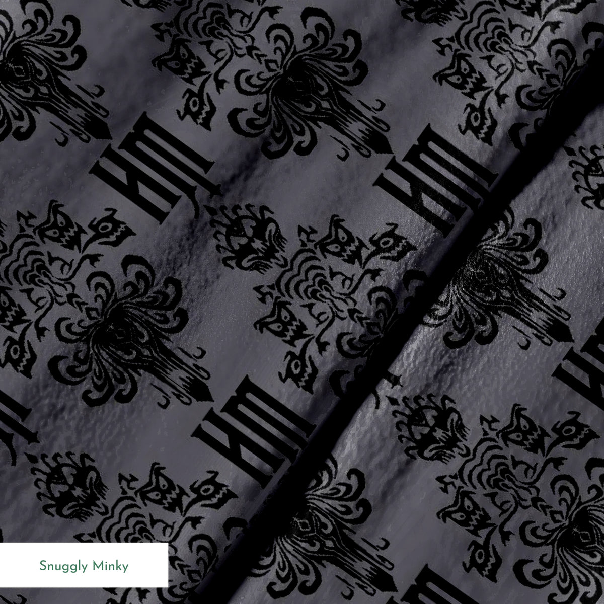 Dark gray background with black ornate damask pattern featuring decorative flourishes and monogram elements springs minky texture