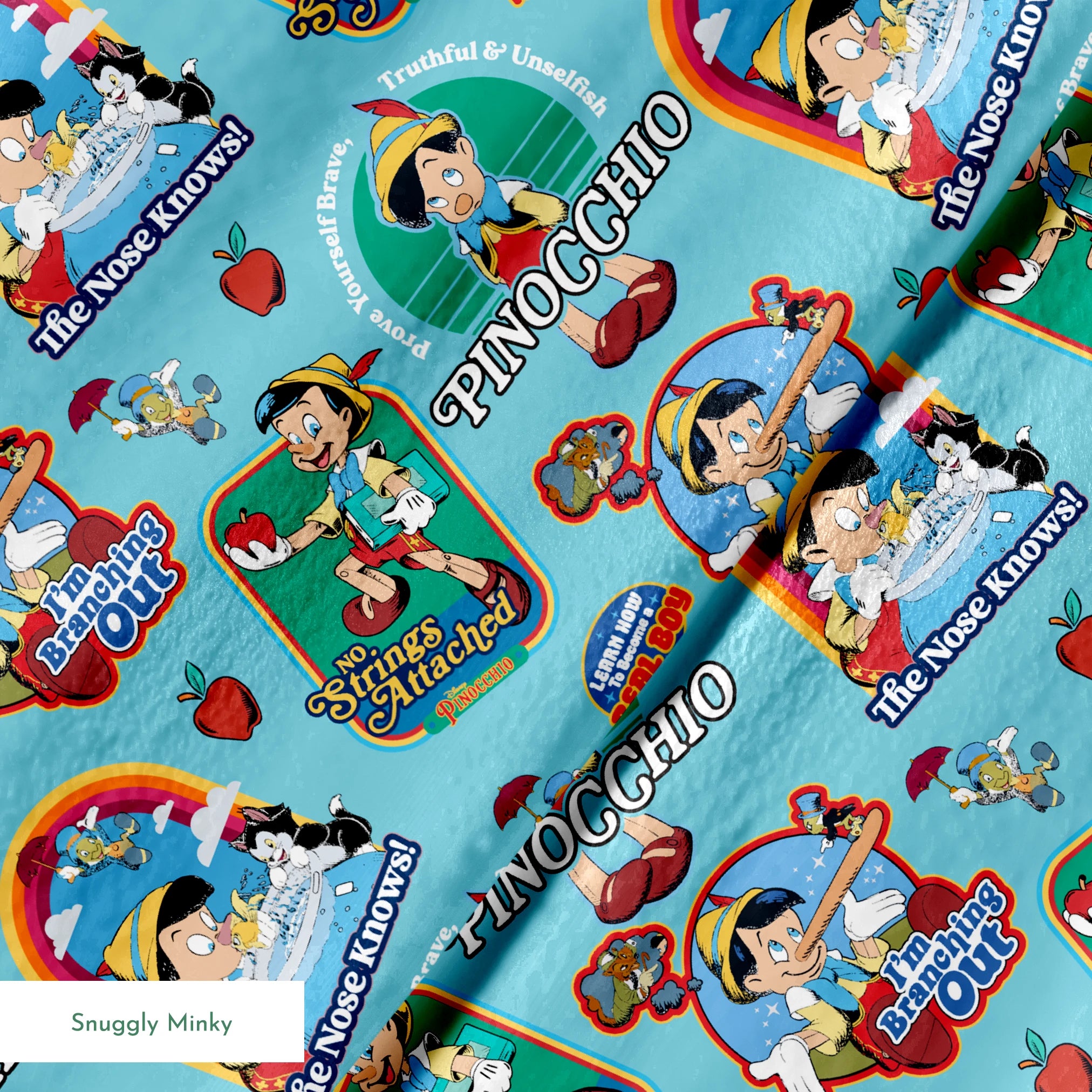 Colorful Pinocchio cartoon pattern featuring puppet characters, slogans, and red apples on teal background springs minky texture