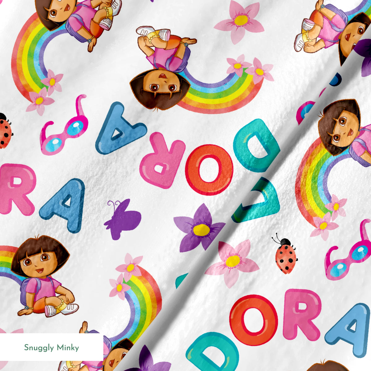 Colorful Dora pattern with rainbows, flowers, alongside scattered "DORA" letters on white background. springs minky texture
