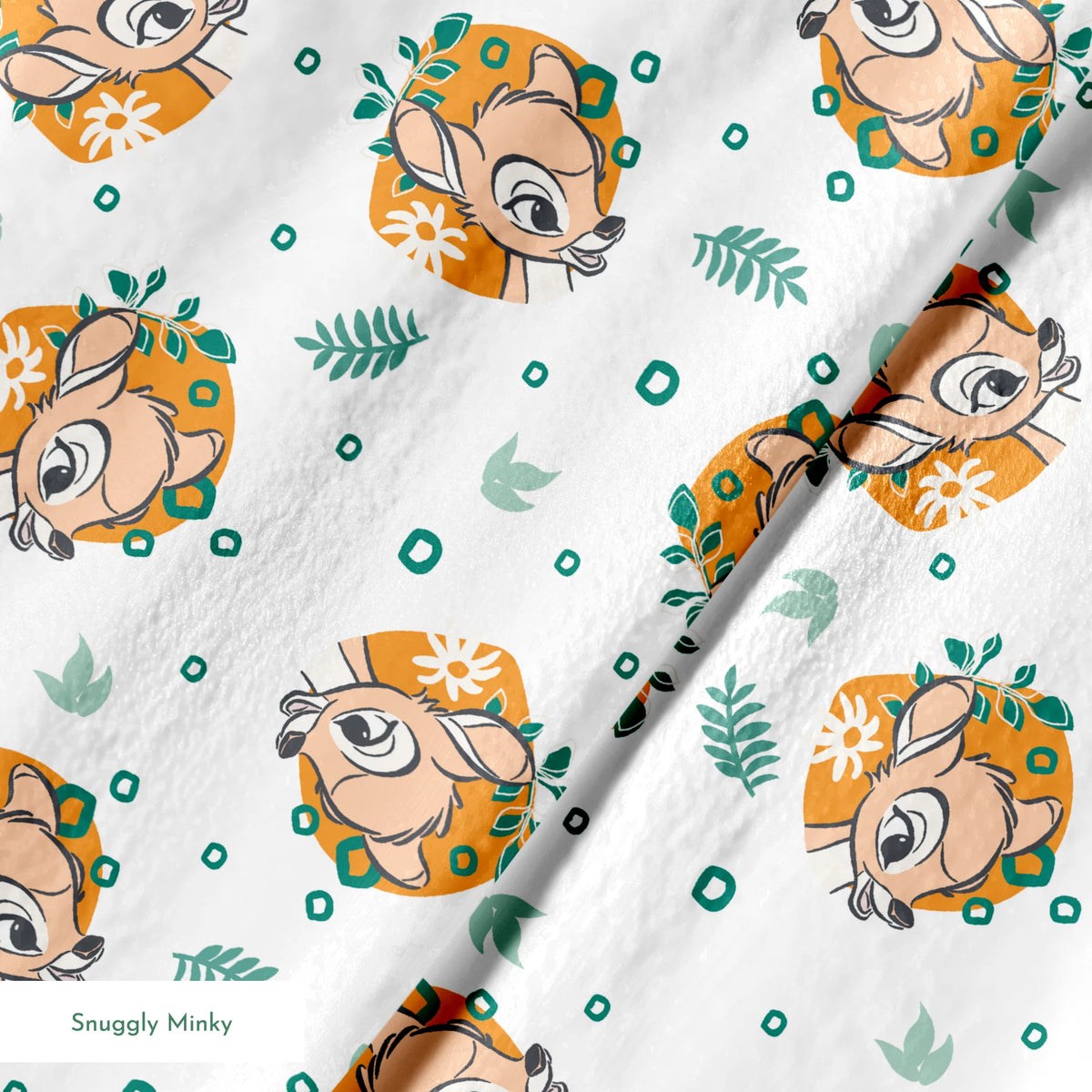 Disney’s Bambi illustrated in golden-orange floral medallions with green leaves and scattered geometric accents on a white background. springs minky texture