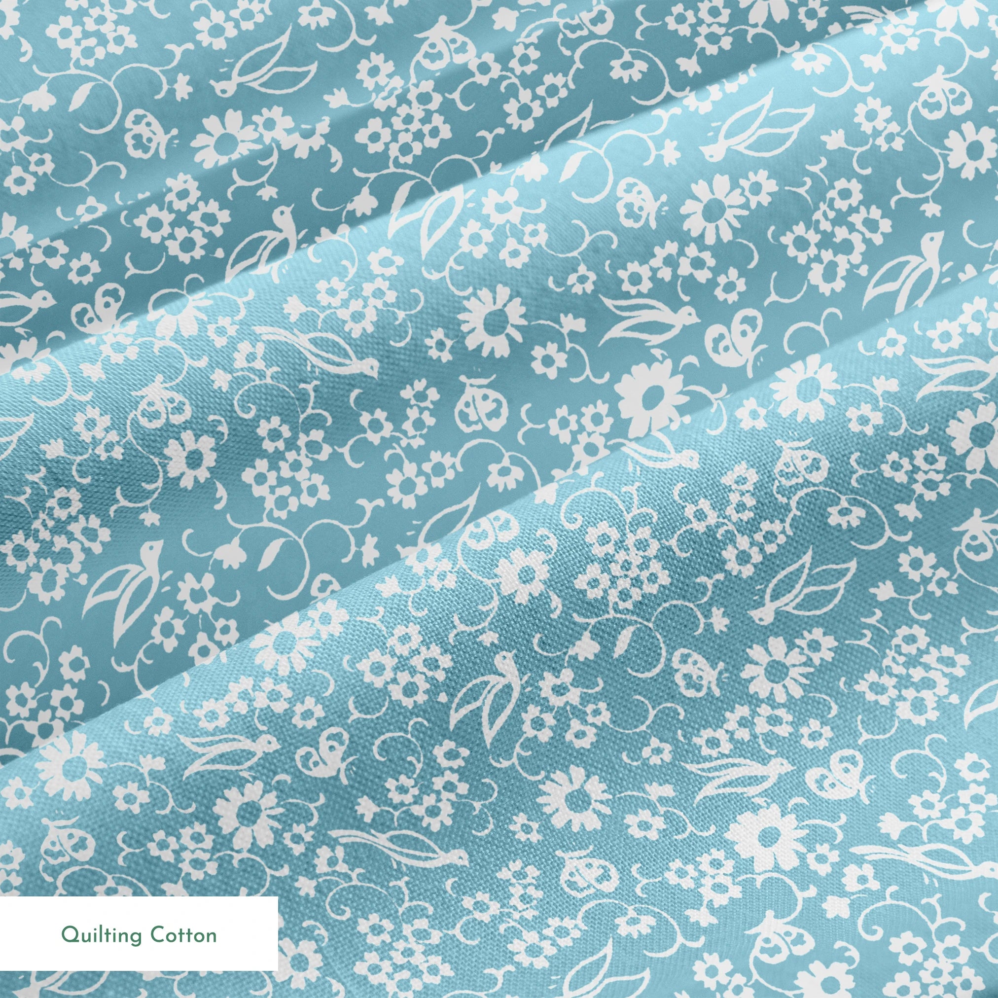 White vintage-style bird and floral silhouettes on a dusty blue background. springs quiltingcotton texture