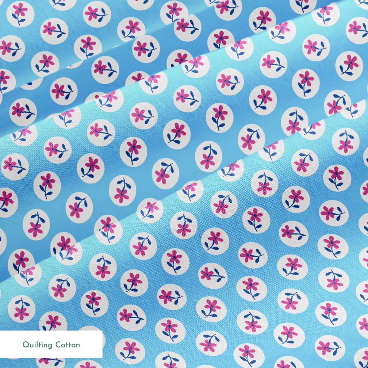 Purple flowers with blue stems inside white circles on light blue background pattern springs quiltingcotton texture