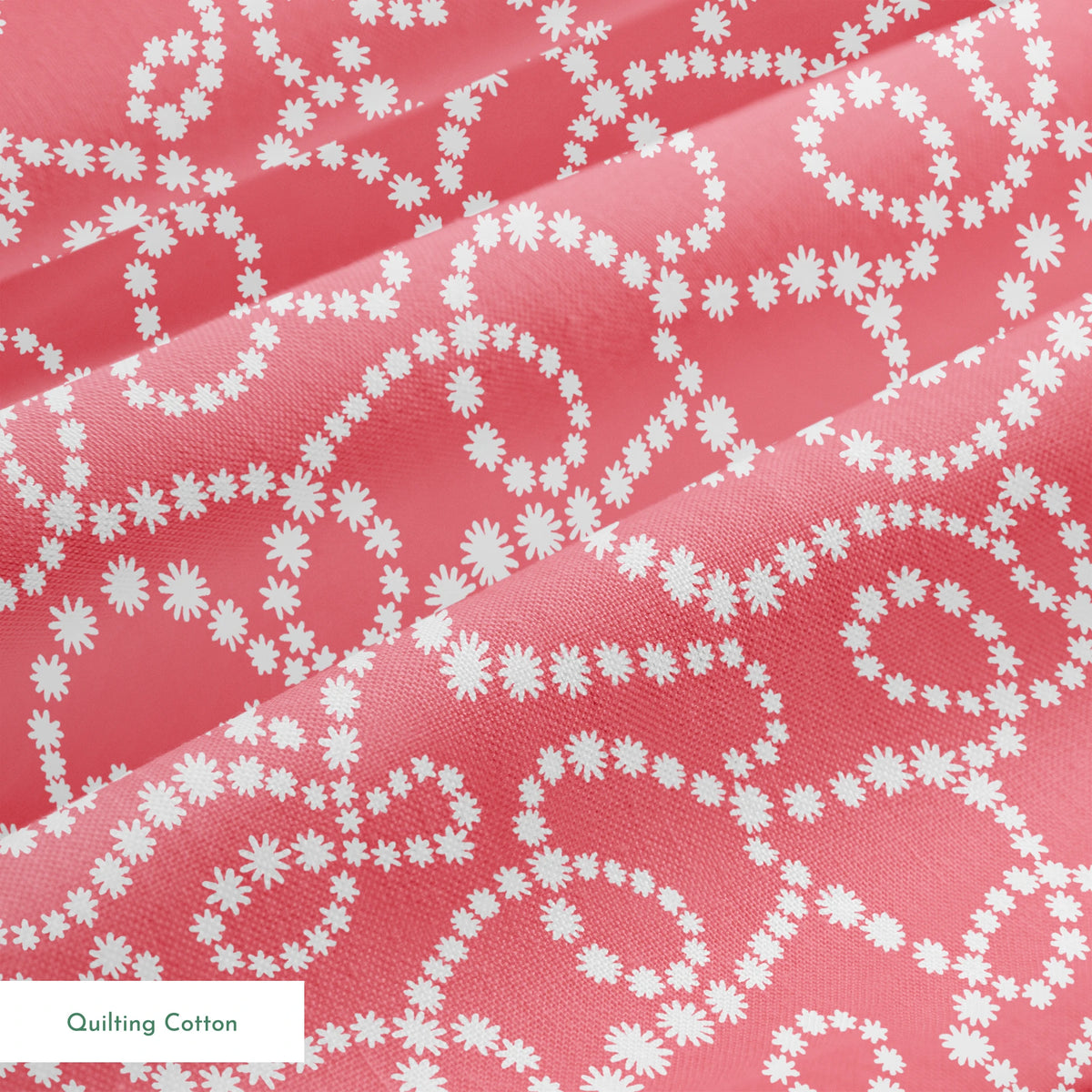 White dot patterns forming swirling chains on coral pink background springs quiltingcotton texture